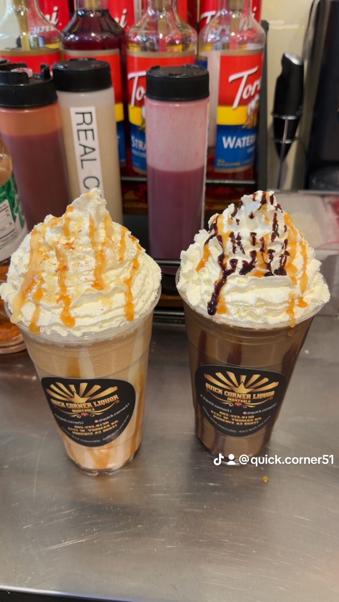 Two whipped-topped frozen coffee-style slushies with caramel and chocolate drizzle