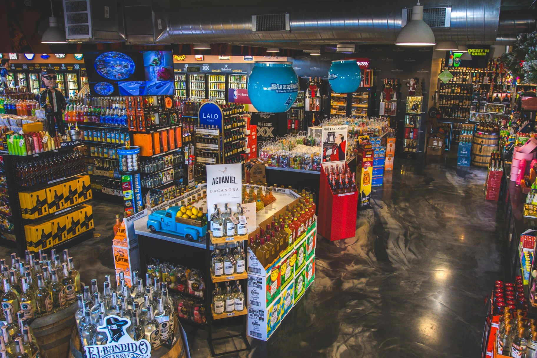 Tequila and ready-to-drink island display featuring Aguamiel, Jose Cuervo, and BuzzBallz