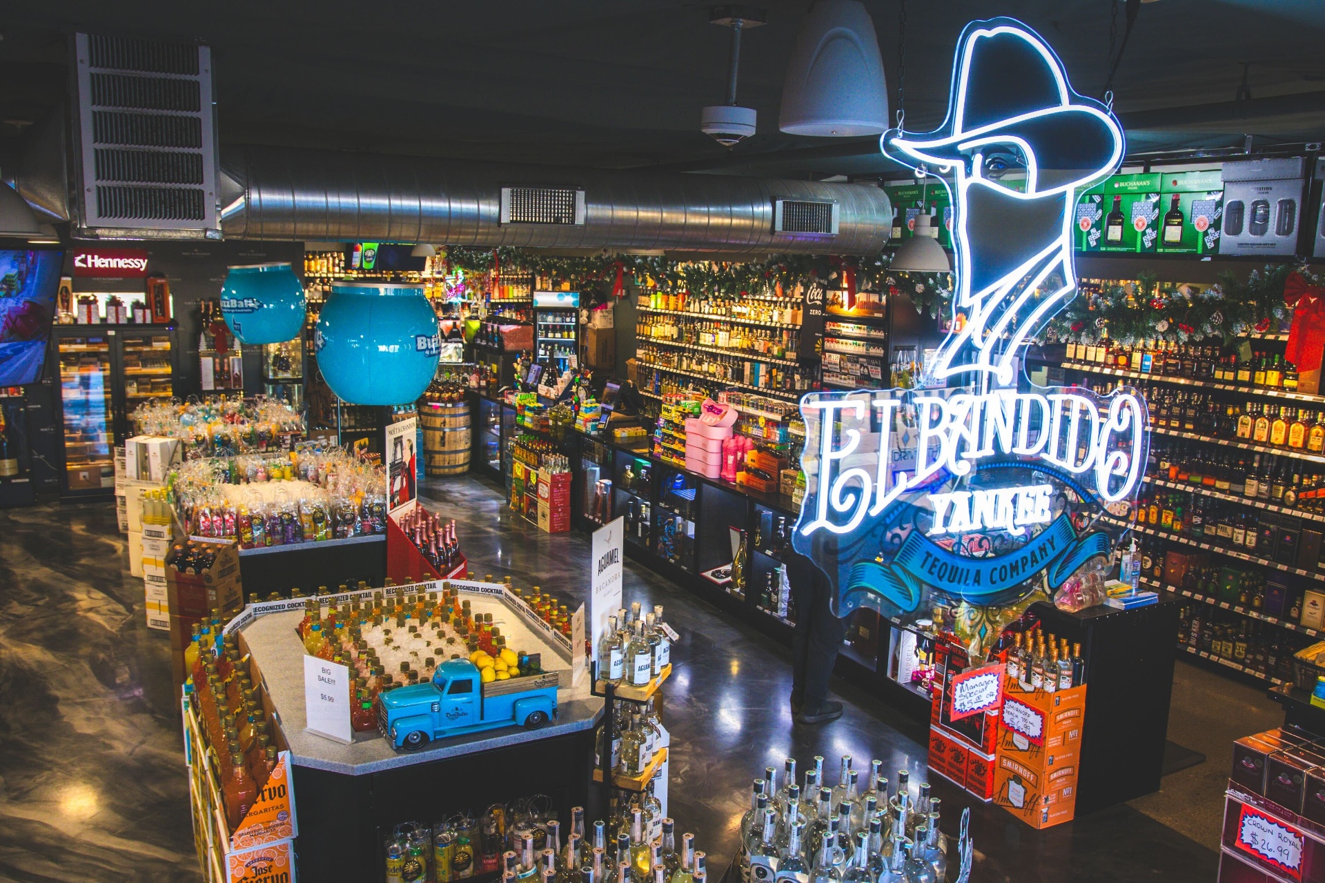 El Bandido Yankee tequila neon sign above the spirits and BuzzBallz display at Quick Corner